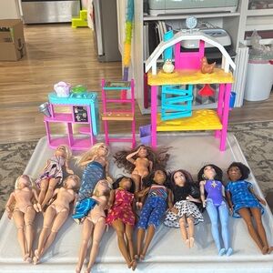 Random assortment of Barbies with some accessories